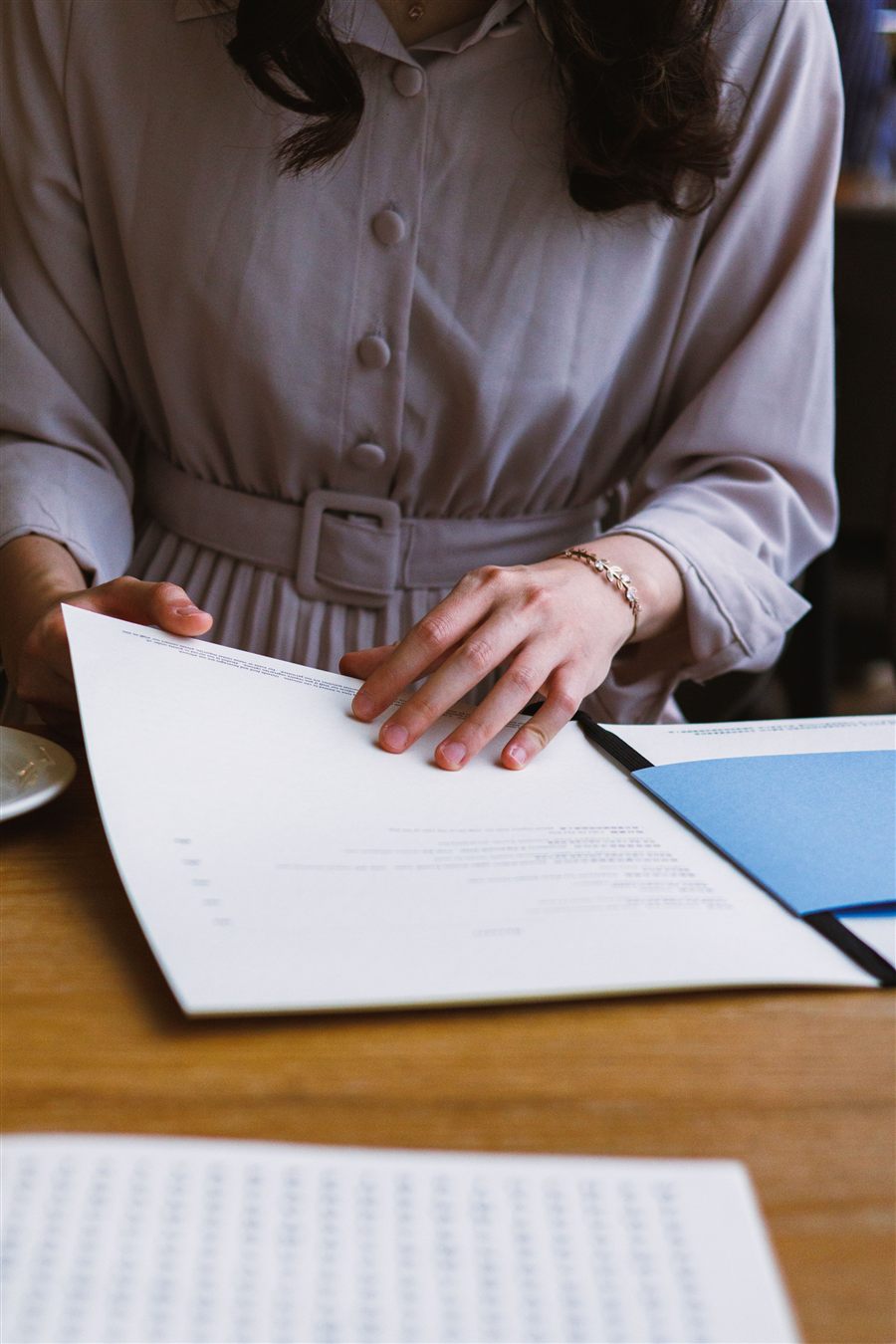 Person reviewing documents at a laptop